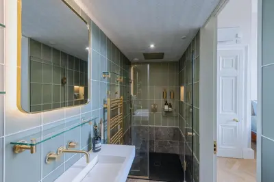 a bathroom with a sink and a shower at Luxury West End flat with stunning bay window views in Edinburgh