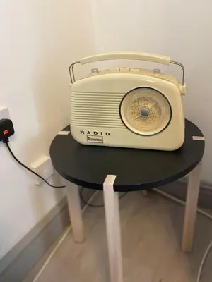 a small table with a radio on top of it at Modern 2Bed Garden Apartment in Heart of Penarth in Moffat