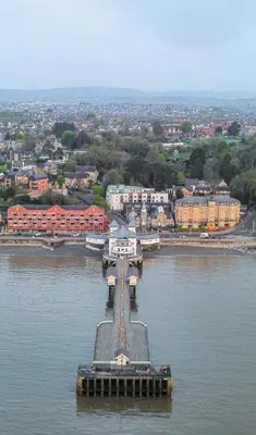 a bridge in the middle of a body of water at Modern 2Bed Garden Apartment in Heart of Penarth in Moffat