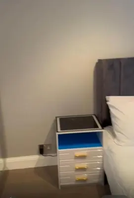 a bed with a night stand next to a bed at 2Bedrooms flat in knightstbridge in Moffat