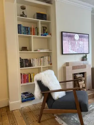 a living room with a book shelf filled with books at Station House in Moffat