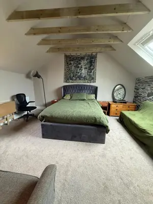 a bedroom with a green bed in a room with ceilings at Fernbank Cottage - Bruichladdich, Isle of Islay in Bruichladdich