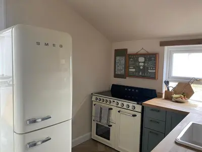 a kitchen with a white refrigerator and a stove at Fernbank Cottage - Bruichladdich, Isle of Islay in Bruichladdich