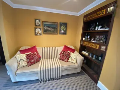 a living room with a couch with pillows on it at Fernbank Cottage - Bruichladdich, Isle of Islay in Bruichladdich