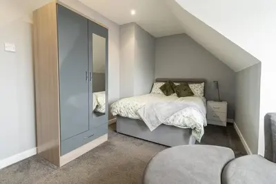 a bedroom with a bed and a large mirror at The Loft - 3 bedroom in Crieff in Crieff