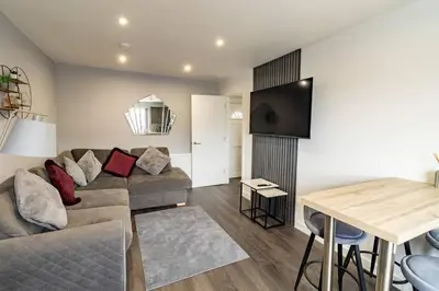 a living room with a couch and a table at The Loft - 3 bedroom in Crieff in Crieff