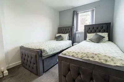 a bedroom with two beds and a window at The Loft - 3 bedroom in Crieff in Crieff