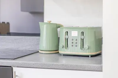 two green toasters sitting on a kitchen counter at Leven Loft - 2 Bed Flat in Coatbridge in Coatbridge
