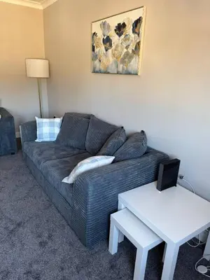a living room with a couch and a table at 3 bedroom Falkirk flat in Falkirk