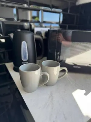 two coffee cups sitting on top of a counter at 3 bedroom Falkirk flat in Falkirk