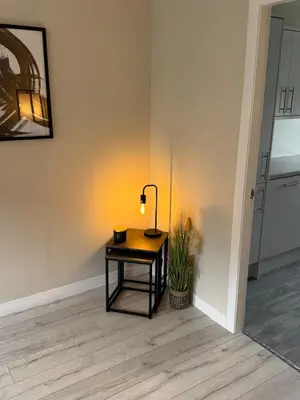 a table with a lamp on it in a room at Newly Renovated Flat Edinburgh - 2 x Double Beds in Edinburgh