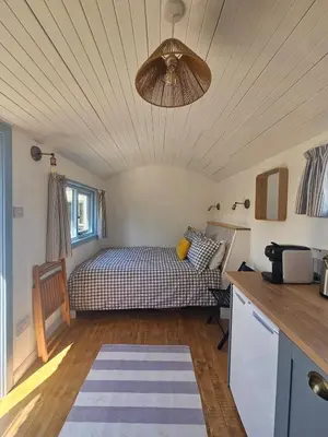 a bedroom with a bed and a ceiling fan at Wee Haven in Inverkeithing