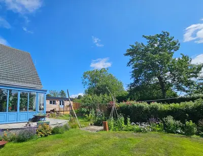 a view of a garden with a house at Wee Haven in Inverkeithing