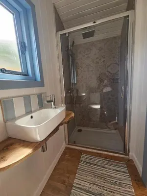a bathroom with a sink and a shower at Wee Haven in Inverkeithing