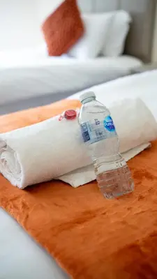 a bottle of water sitting on top of a towel at Curtis Apartment in Glasgow
