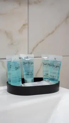 a display of two products on a shelf in a bathroom at Curtis Apartment in Glasgow