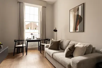 a living room with a couch and a table at Moment Blythswood St in Glasgow