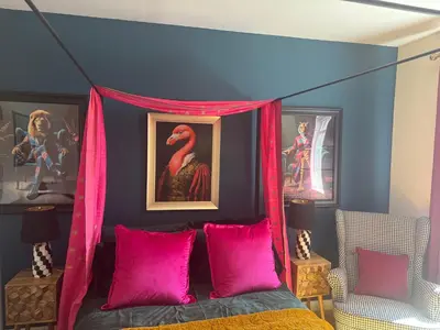 a bedroom with a canopy bed with pink pillows at Jett Joy in Moffat