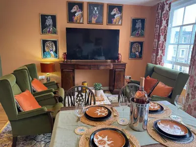 a living room with a table and a television at Jett Joy in Moffat