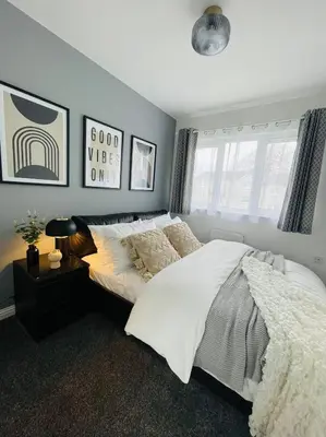 a bedroom with a bed with white sheets and pillows at Elegant 3BR house in Glasgow in Garthamlock