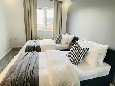 a bedroom with two beds with pillows on them at Elegant 3BR house in Glasgow in Garthamlock