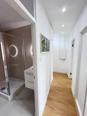a room with a hallway with a painting on the wall at Flat in London Bridge in Moffat