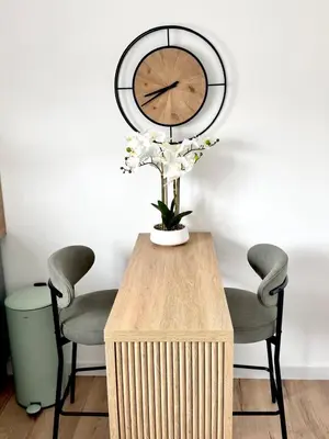 a vase of flowers on a table with two chairs at Almondvale Apartment in Livingston