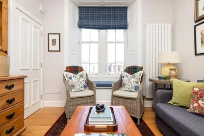 a living room with a couch and chairs at Edinburgh Stockbridge Charm Apartment in Edinburgh