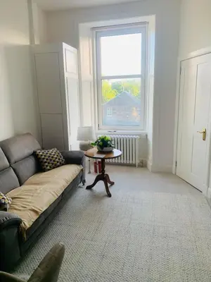 a living room with a couch and a table at Rachael's House in Moffat