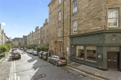 a street with cars parked in front of buildings at Haymarket Edinburgh Flat Sleeps 4 in Edinburgh