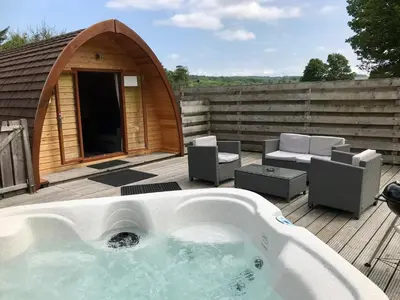 a hot tub on a deck with a gazebo at Queensland Holiday Park - Glamping in South West Scotland in Barrhill