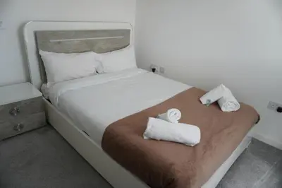 a bedroom with a bed with towels on it at Detached Home in Bishopton in Bishopton