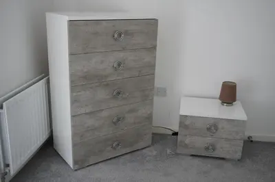 a wooden dresser in a room with a table at Detached Home in Bishopton in Bishopton