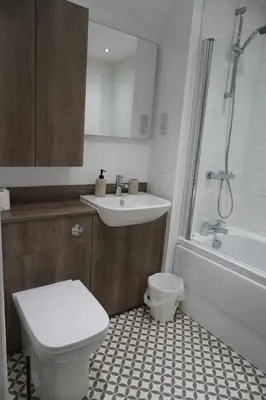 a bathroom with a toilet and a sink and a bath tub at Detached Home in Bishopton in Bishopton