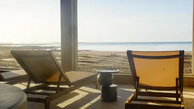 two chairs in a room with a view of the ocean at The Waterside Hotel & Spa in Seamill