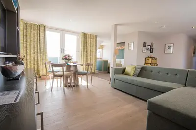 a living room with a couch and a table at The Waterside Hotel & Spa in Seamill