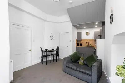 a living room with a couch and a table at Sleek Canalside Stay in Edinburgh in Edinburgh