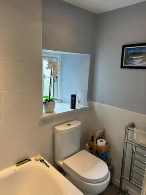 a bathroom with a toilet and a sink and a window at Modern One Bed Flat, Historic Old Town Edinburgh in Edinburgh