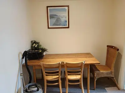 a dining room table with chairs and a picture on the wall at Glasgow Property New City Rd in Glasgow