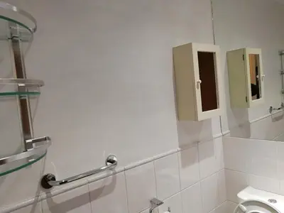 a bathroom with a toilet and a mirror at Glasgow Property New City Rd in Glasgow
