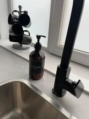 a bottle of soap sitting next to a sink at Foundry Street Apartment 3 - Dunfermline City Centre in Dunfermline