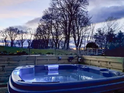 a large blue bath tub sitting in a yard at Bendhu in Mill of Fortune