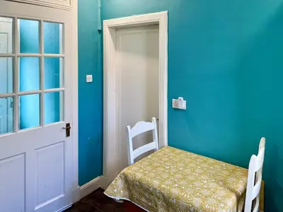 a room with a table and two chairs and a door at Homely Base in Crossgates