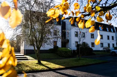 a white building with a tree in front of it at 28 Guthrie Court - Gleneagles Village