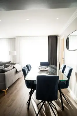 a living room with a dining room table and chairs at 28 Guthrie Court - Gleneagles Village