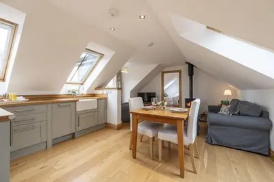 a kitchen and dining room with a table and a couch at The Keep in Kirknewton