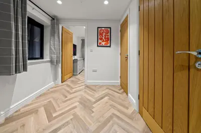 a hallway with wood flooring in a house at The Salt Room Modern 1 Bedroom Home By AltoLuxo Short Lets Serviced Accommodation With Free Wifi & Parking in Moffat