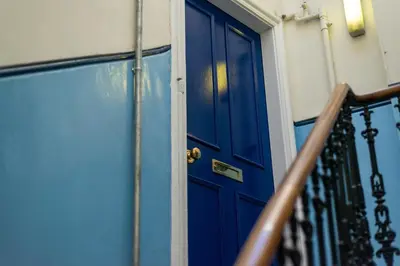 a blue door on the side of a building at Cosy 2-bedroom Edinburgh flat close to city centre in Edinburgh