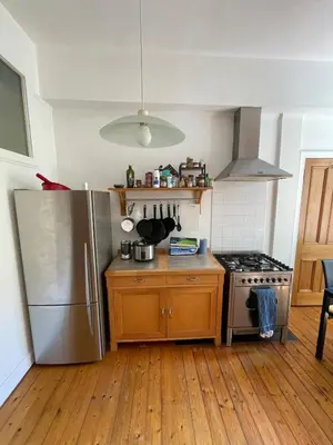 a kitchen with a stainless steel refrigerator and a stove at Charming flat in beautiful area in Edinburgh