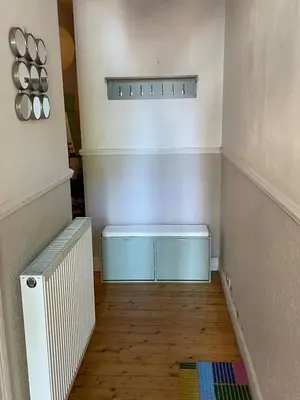 a hallway with a blue radiator and a floor at Charming flat in beautiful area in Edinburgh